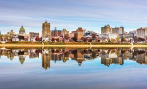 A photograph of Harrisburg city reflected in the Susquehanna River. 