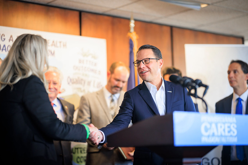 A photograph of Governor Shapiro shaking hands at an Autism event. 